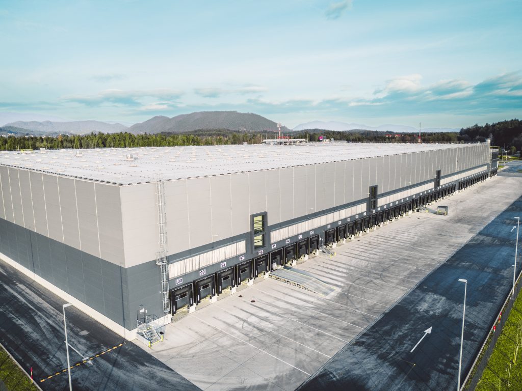 Large logistics warehouse with loading bays and spacious truck access area.