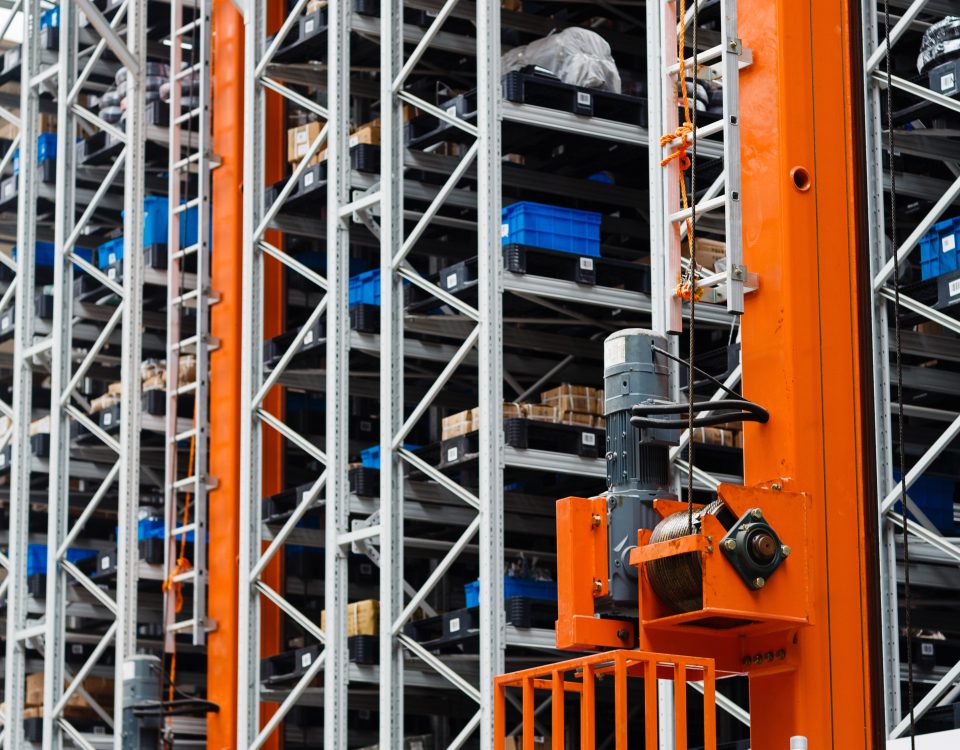 High-bay automated warehouse racking system with storage lifts and inventory shelves