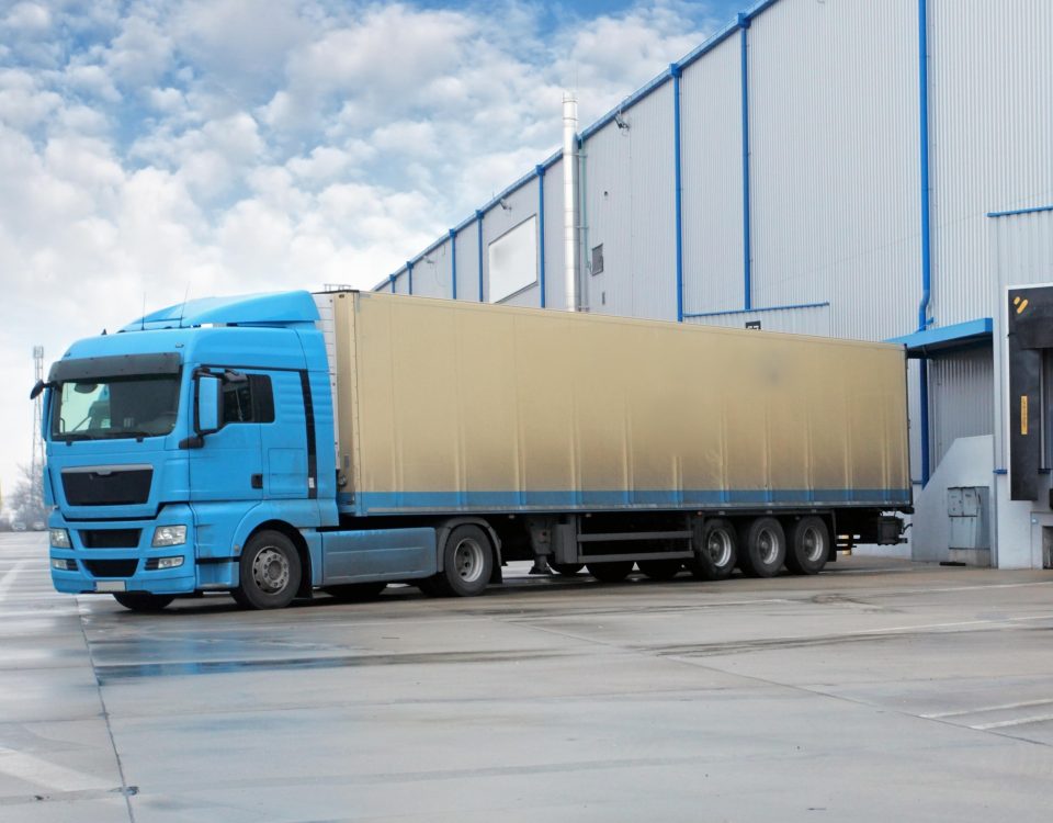 Logistics truck docking at a warehouse loading bay for outbound delivery