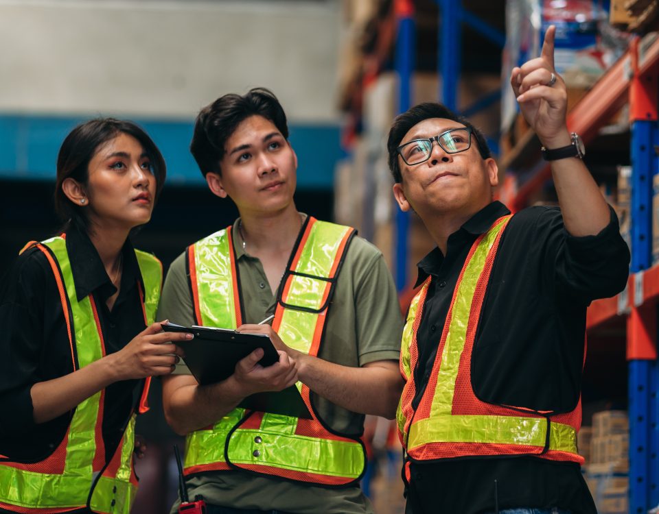 Warehouse team checking stock levels and coordinating inventory inside a storage facility